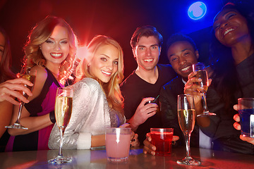 Image showing Portrait, clubbing and drinking with friends together in a nightclub for a new year celebration party. Happy, drink and cocktail with a man and woman friend group bonding in a nightclub for fun
