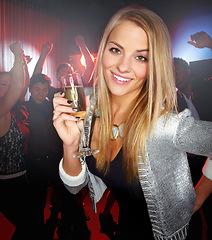 Image showing Night club, party and woman with champagne to celebrate, techno smile and social at a rave event. Rock disco, happy concert and portrait of a girl at a club new year celebration with a drink