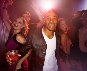 Image showing Party, happy or friends in a club to dance in celebration of New Years or fun Birthday with black man or alcohol. Excited, diversity or happy people dancing to disco music at crazy social event night