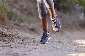 Image showing Running, training and shoes of black woman on path of mountain for cardio, workout and exercise. Fitness, health and cardio with girl runner jogging on park trail for endurance, performance and goal