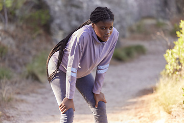 Image showing Fitness, mountain and black woman tired from running, marathon training and exercise in nature. Wellness, endurance and female athlete taking a break, rest and breathe to relax after sports workout