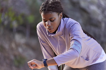 Image showing Black woman runner, smartwatch and rest for breathing, heart rate or health while training in summer. Woman, running and healthcare tech for exercise, workout and fitness at nature park in California