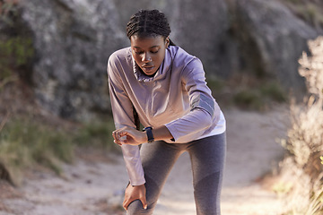 Image showing Fitness, nature and woman with time on watch for running speed, progress check and steps monitor on smartwatch or digital technology. Runner, athlete or black woman in mountains training with a timer