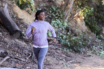 Image showing Black woman, running and exercise in forest with happy smile, workout and exercise for health and wellness outdoor. Young female, runner and fitness while training marathon, happy smile and run