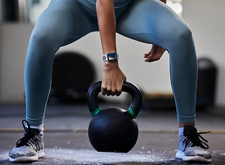 Image showing Woman hand, kettlebell and gym floor in training, fitness or muscle development with smartwatch. Bodybuilder girl, weightlifting and strong with sneakers, chalk powder and focus on exercise in studio