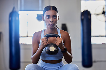 Image showing Kettlebell, fitness and training black woman or workout bodybuilder in a gym studio for muscle wellness, body goals and power. Focus, breathing and a strong sports athlete with training gear exercise