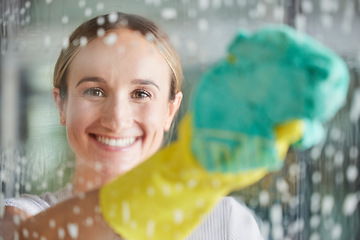 Image showing Cleaning, washing and portrait of woman by window with foam, cleaning products and cloth for housework. Spring cleaning, housekeeping and happy girl wipe dirt and dust on glass window for clean home