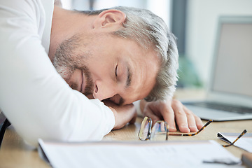 Image showing Burnout, sleeping and tired business man at his desk for financial report, audit or tax documents with time management fail or mental health risk. Fatigue, depression and sad businessman in workplace