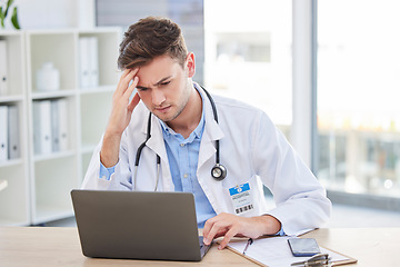 Image showing Doctor, laptop and stress headache about bad news or diagnosis for medical professional in his office. Hospital, clinic and male gp specialist reading email and feeling upset with a migraine