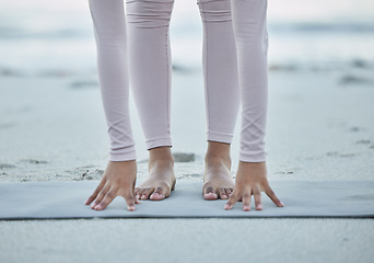 Image showing Fitness, yoga and legs of woman at the beach for stretching, exercise and pilates training in nature. Mindfulness, motivation and hands and feet of girl for workout, balance and performance by ocean