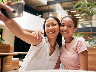 Image showing Phone, friends and women taking a selfie in restaurant for social media post, social network and memories. Friendship, smartphone and happy girls take photo enjoying quality time, freedom and weekend