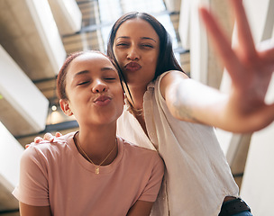Image showing Peace, kiss and pout with black woman friends in the city together, posing with a hand sign or gesture. Happy, smile and bonding with a young female and her best friend in an urban town from below