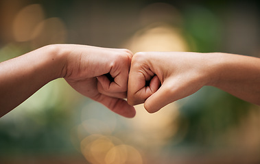 Image showing Fist bump, friends and hands together for welcome with support, diversity and partnership collaboration. Bokeh background, racism and friendship goal welcome greeting collaboration outdoor with bokeh