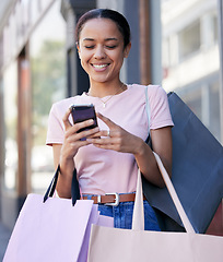 Image showing Woman, phone and shopping, luxury and reading discount, sale and promotion on internet outdoor a retail store in Paris. Happy female, smile and mobile smartphone, online shopping and ecommerce