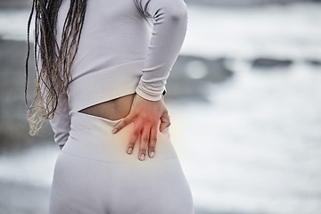 Image showing Back pain, red and hand for fitness massage at beach with running, exercise or workout injury of anatomy, wellness and medical insurance. Healthcare, cardio and black woman with fitness pain at sea