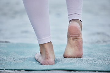 Image showing Woman in yoga stretching feet at a beach training legs in a holistic foot exercise or workout in nature. Fitness, wellness or spiritual zen girl exercising for balance or healthy strong body alone