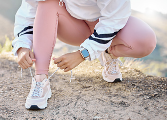 Image showing Shoe, hand and woman tie lace for fitness, sport and run in nature for exercise and training workout. Athletic, athlete and footwear of a female sports runner prepare for running marathon outside