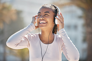 Image showing Happy, fitness or black woman with headphones for a podcast, music or radio streaming for motivation in Miami. Nature, smile or healthy girl runner laughing at a funny audio after training exercise