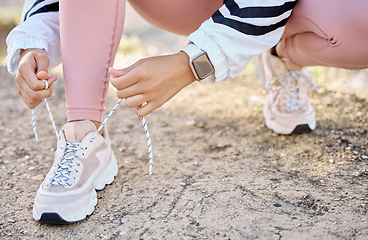 Image showing Shoe, fitness and woman prepare for athletic marathon in nature for cardio health and wellness. Footwear, hand and ground with a female athlete getting ready for exercise or workout in a park