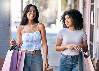 Image showing Friends, shopping and walking together while happy, talking and laughing outdoor at city mall while excited about sale, deal and promotion for savings. Women in Milan for retail customer experiene