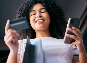 Image showing Black woman, shopping bag and ecommerce credit card for phone purchase with cheerful smile low angle. Payment, 5g and online shopping girl with smartphone for retail app promotion code benefit.