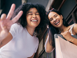 Image showing Friends, happy shopping and peace sign portrait in city for retail therapy freedom, quality time and customer happiness. Luxury usa store, shopping bag and black women smile for fashion promotion