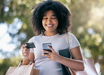 Image showing Woman, shopping and phone with credit card for ecommerce purchase or payment outside. Online, mobile and fintech for retail sale or discount pay with a female shopper buying with e commerce