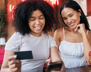 Image showing Credit card, friends and women with phone for ecommerce, banking or payment in restaurant. Mobile smartphone, online shopping fintech and happy girls paying for order with debit card in coffee shop.