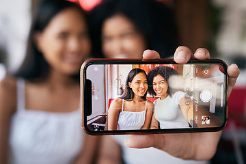 Image showing Woman friends, selfie and phone screen for social media, blog post or bonding in restaurant. Happy black woman, influencer group and smartphone picture for social network, app or internet with smile