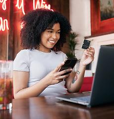 Image showing Credit card, phone and woman on laptop in cafe online shopping, ecommerce website payment for fashion sale. Black woman, retail customer and smartphone bank app or internet finance in coffee shop