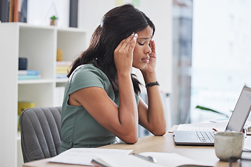 Image showing Black woman, stress and headache on laptop working at the office suffering from mental health issues. African female employee sitting by computer desk in pain, burnout or anxiety at the workplace