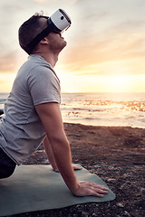 Image showing VR, yoga and man stretch on the beach for fitness, flexibility and health and wellness at sunset. Metaverse, ai and futuristic male yogi with a headset and yoga mat for training and ocean pilates