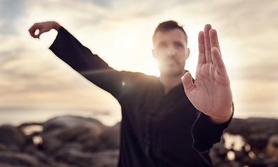 Image showing Fitness, karate or man in nature training his body in a relaxing zen meditation with focus or calm sea energy. Chakra, hands or healthy martial arts expert exercising mindfulness or tai chi balance