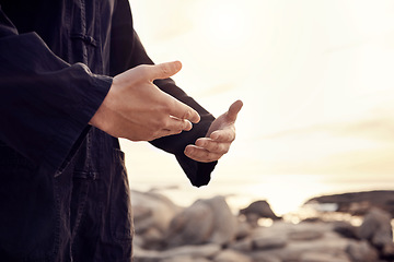 Image showing Hands of Tai Chi man or meditation by beach, sea or ocean for mindset wellness, zen or fitness sport health. Zoom, martial arts or man in sunset for chakra training, peace exercise or karate workout