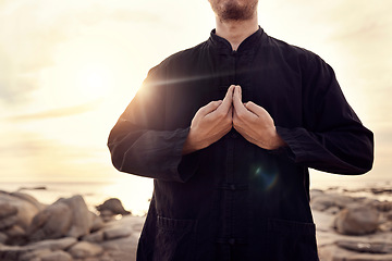 Image showing Tai chi, martial arts and man with hands on beach for fitness and meditation, balance energy and healing at sunrise with self defense exercise. Calm, peace and zen outdoor, karate and wellness.