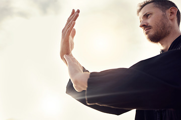 Image showing Karate, tai chi wellness or man on beach, sea or ocean for zen, fitness training or sports health in sunset lens flare. Focus, mindset or athlete for chakra exercise, peace or defense workout outdoor