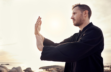 Image showing Man, hands or relax tai chi on sunset beach in fitness, workout or training in mental health, chakra energy or mind balance. Zen, martial arts or person by ocean sea, nature water or sunrise exercise