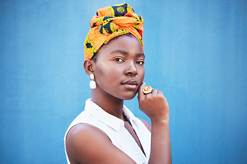 Image showing Portrait, black woman and turban with makeup or relax on blue studio background. Nigerian female, girl or lady with traditional head wrap, natural beauty or cosmetics for smooth, clear skin or mockup