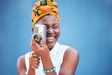 Image showing Face, photographer and black woman with camera in studio isolated on a blue mock up background. Photography, tech and happy female from Nigeria with camcorder taking pictures, photo or photographs.