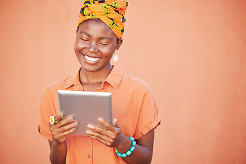 Image showing Face, tablet and black woman on social media in studio on an orange mockup background. Tech, smile and happy female from Nigeria streaming video, movie or internet browsing on digital touchscreen.