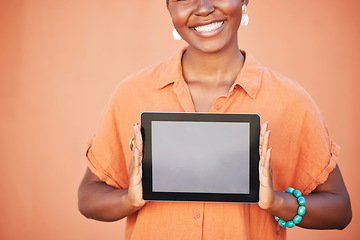 Image showing Happy, girl and hands with tablet app mockup for marketing with optimistic smile holding touchscreen. Digital, advertising and empty tech screen of black woman at orange wall background.