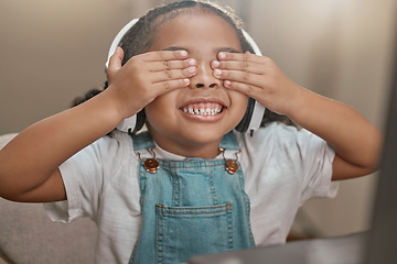 Image showing Girl, video call and child play peekaboo in home, smiling and having fun. Face, headphones and kid in webinar, online conference or video chat in house playing hide and seek enjoying time on laptop.