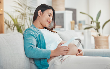 Image showing Pregnant, woman and stomach with headphones for music for her unborn baby while relaxing at home. Belly, baby bump and pregnancy with a mother using a headset for audio or podcast streaming