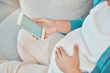 Image showing Pregnant woman, phone screen and space for product placement on internet for marketing and advertising pregnancy app on home sofa. Hand of female touching stomach while online reading about maternity