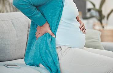 Image showing Back pain, pregnancy and woman relaxing on a sofa in her living room at her modern house. Medical emergency, injury and pregnant lady with a swollen body, physical inflammation and backache at home.