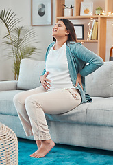 Image showing Pregnant, back pain and woman with ache and body strain while sitting on her living room sofa. Belly, anatomy and pregnancy discomfort with a painful mother unhappy with physical condition at home
