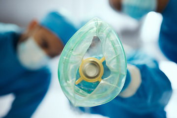Image showing Closeup oxygen mask, ventilation and doctors in hospital of emergency healthcare, surgery or medicine in operating room. Breathing machine, ventilator and air for patient, lungs and medical operation