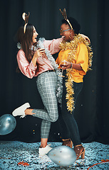 Image showing Women friends, party and night with balloons, tinder or wine in new year, celebration or happiness. Woman diversity, hug and glass for drinks, happy or dark background for glitter confetti on floor