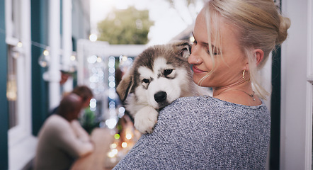 Image showing Woman holding her dog with love, care and happiness at a dinner, party or celebration at a house. Happy, smile and lady hugging her husky pet at a festive, new year or christmas event at home.