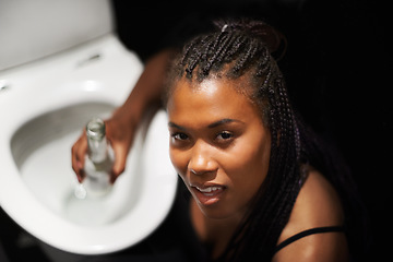 Image showing Drunk, party and bathroom nausea of a black woman with a alcoholic problem and addiction. Toilet, drinking abuse and African female portrait with a beer bottle at night with alcohol drink feeling ill